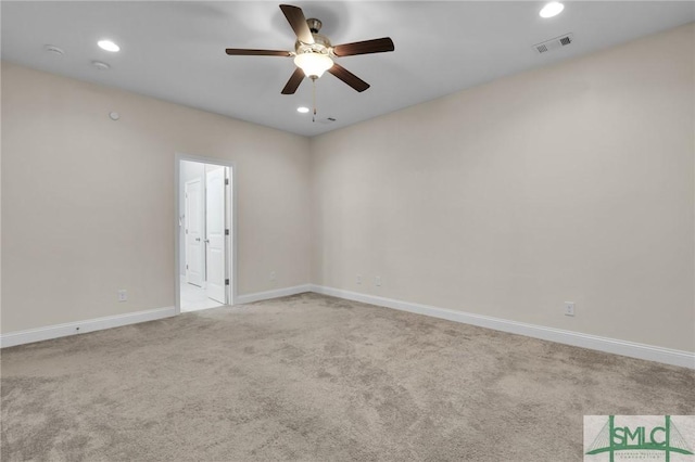 spare room featuring light carpet and ceiling fan