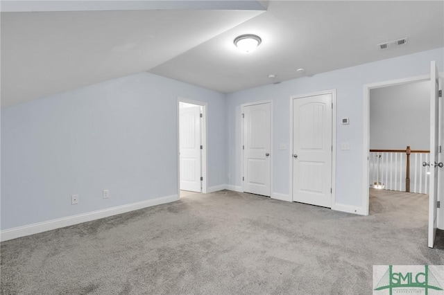 additional living space with light colored carpet and lofted ceiling