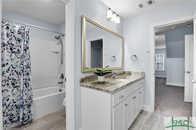 full bathroom featuring shower / bathtub combination with curtain, vanity, and toilet