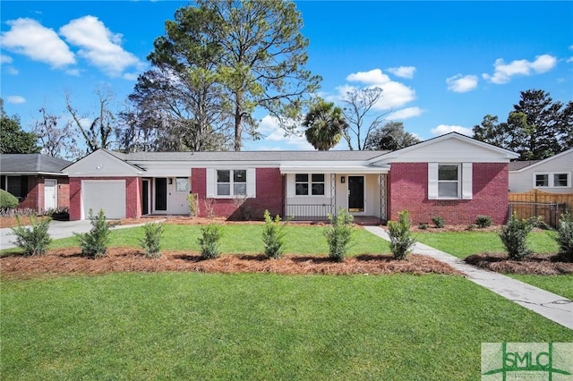 single story home featuring a garage, a front yard, and covered porch