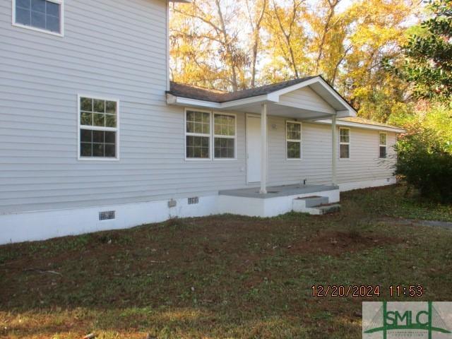 back of house with a lawn