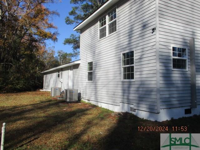 view of property exterior featuring cooling unit and a yard