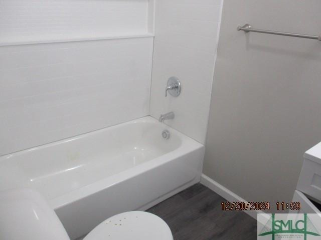 full bathroom with hardwood / wood-style flooring, vanity, bathtub / shower combination, and toilet