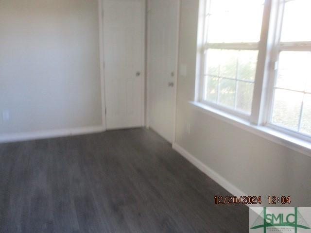 unfurnished room with dark hardwood / wood-style floors