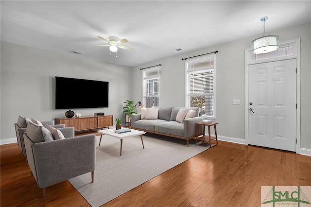 living room featuring hardwood / wood-style flooring and ceiling fan