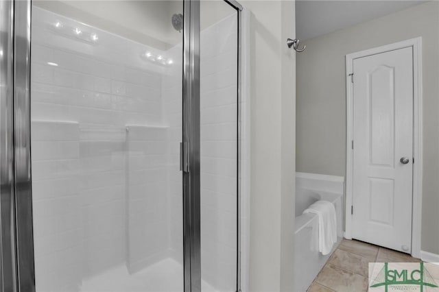 bathroom with walk in shower and tile patterned flooring