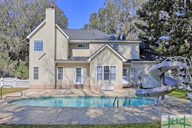 216 Olde Towne Rd, Savannah, GA 31410 - rear view of house with a patio area, a chimney, and an outdoor pool
