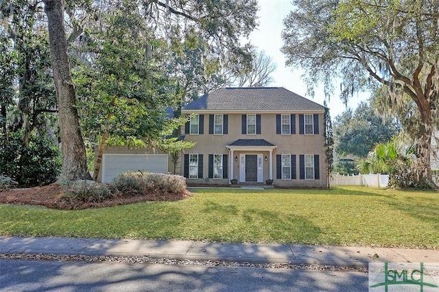 216 Olde Towne Rd, Savannah, GA 31410 - colonial home with an attached garage and stucco siding