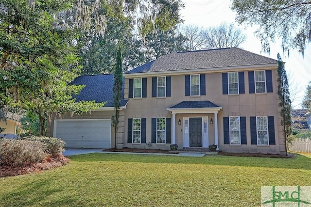 216 Olde Towne Rd, Savannah, GA 31410 - colonial-style house with a garage, driveway, stucco siding, and roof with shingles