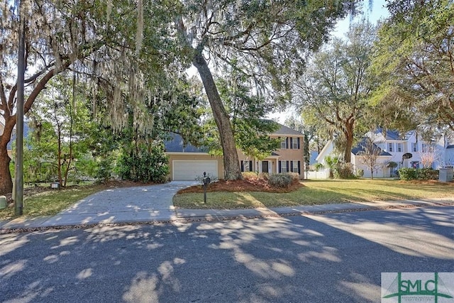 216 Olde Towne Rd, Savannah, GA 31410 - view of front of house featuring concrete driveway, a front lawn, and an attached garage