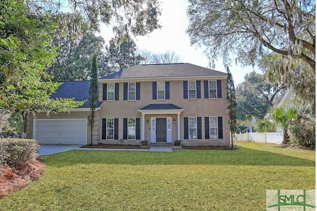 colonial home with a front yard and a garage