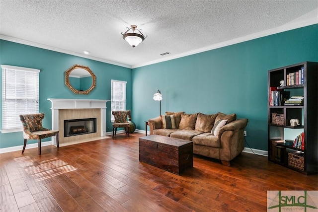 216 Olde Towne Rd, Savannah, GA 31410 - living room featuring crown molding, a fireplace with flush hearth, a textured ceiling, hardwood / wood-style floors, and baseboards