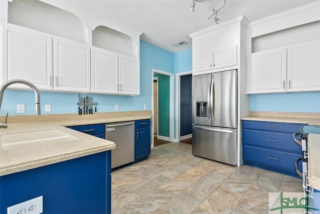 216 Olde Towne Rd, Savannah, GA 31410 - kitchen with appliances with stainless steel finishes, blue cabinetry, a sink, light countertops, and white cabinetry