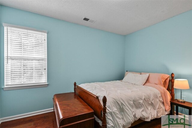 216 Olde Towne Rd, Savannah, GA 31410 - bedroom featuring wood finished floors, baseboards, and a textured ceiling