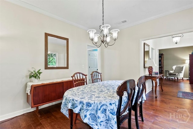 216 Olde Towne Rd, Savannah, GA 31410 - dining area featuring crown molding, a chandelier, dark wood-type flooring, and baseboards