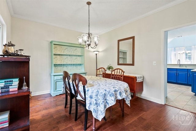 216 Olde Towne Rd, Savannah, GA 31410 - dining area featuring a chandelier, wood finished floors, baseboards, and ornamental molding