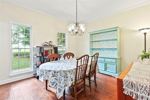 216 Olde Towne Rd, Savannah, GA 31410 - dining room with a chandelier, plenty of natural light, wood finished floors, crown molding, and baseboards