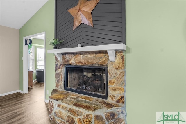 interior details with wood-type flooring and a fireplace