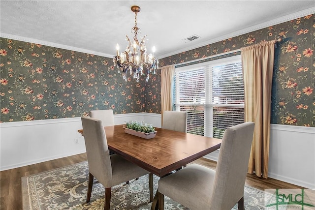 dining space featuring wood-type flooring and a chandelier