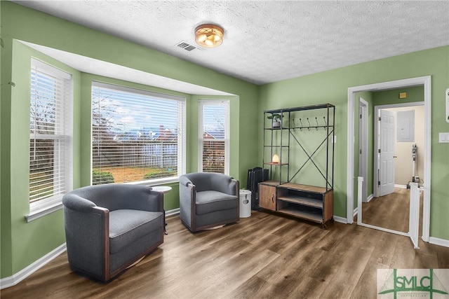 living area featuring dark wood-type flooring and a textured ceiling