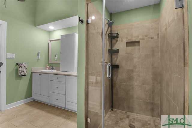 bathroom featuring vanity, tile patterned floors, and a shower with shower door