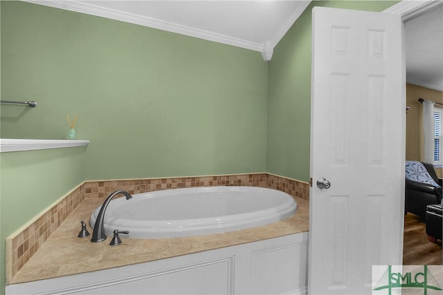 bathroom with crown molding and a tub to relax in