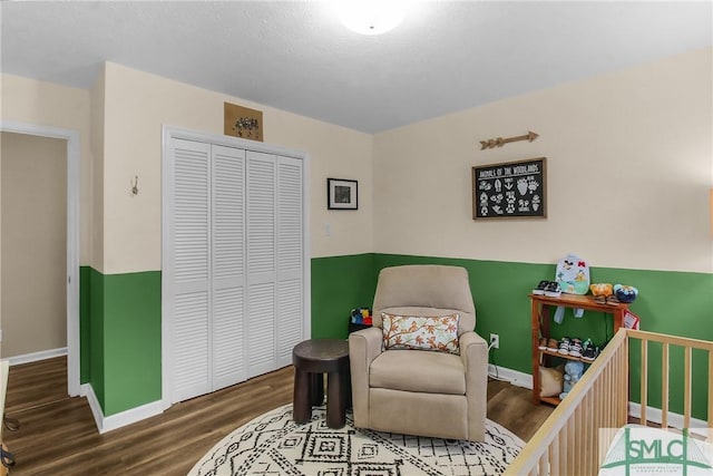 bedroom with wood-type flooring and a closet