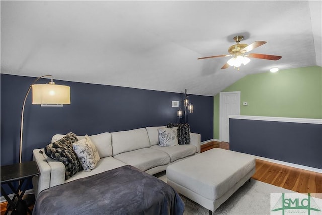 living room with lofted ceiling, hardwood / wood-style floors, and ceiling fan