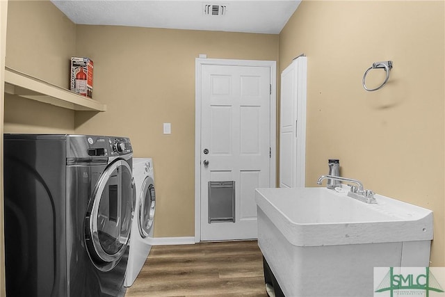 laundry area featuring dark hardwood / wood-style floors and washing machine and dryer