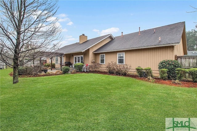 rear view of house with a yard