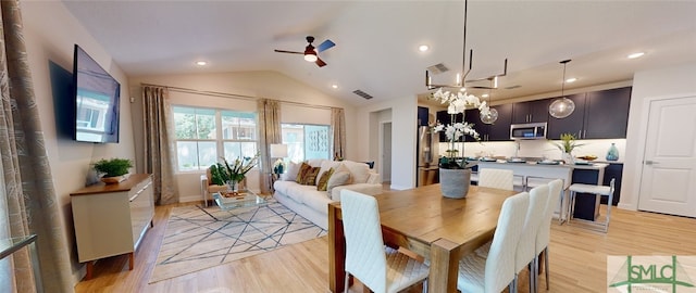 dining room featuring recessed lighting, visible vents, light wood-style flooring, and vaulted ceiling