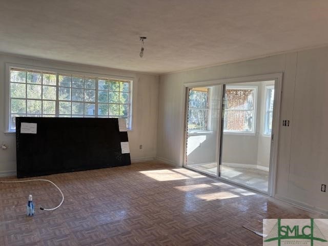 interior space with parquet flooring and a wealth of natural light