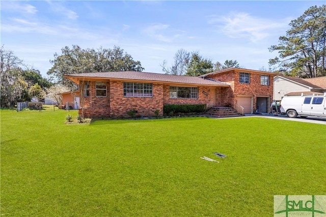 tri-level home with a garage, brick siding, driveway, and a front lawn