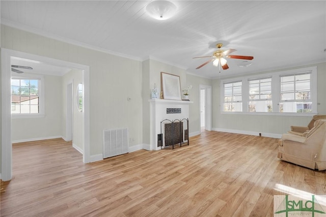 unfurnished living room with ceiling fan, ornamental molding, and light hardwood / wood-style flooring