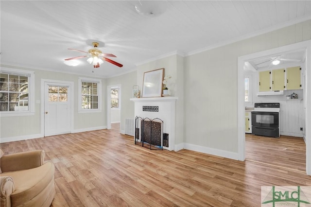 unfurnished living room featuring light hardwood / wood-style flooring, ceiling fan, and ornamental molding