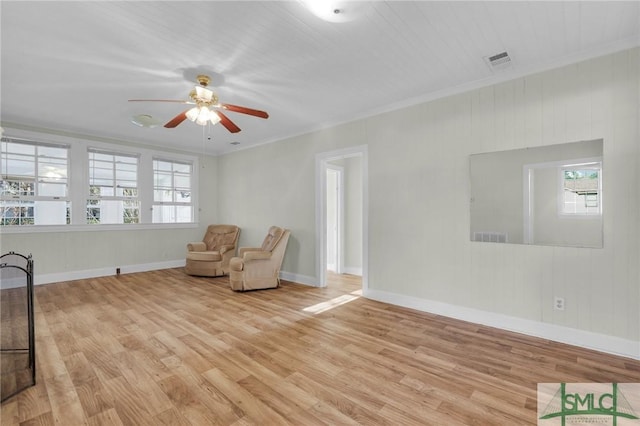 unfurnished room with light wood-type flooring, ceiling fan, and ornamental molding