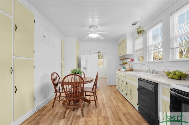 kitchen featuring light hardwood / wood-style flooring, white refrigerator with ice dispenser, dishwasher, ceiling fan, and sink