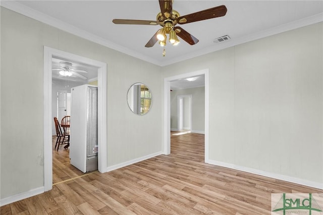 unfurnished room featuring ceiling fan, light hardwood / wood-style flooring, and crown molding