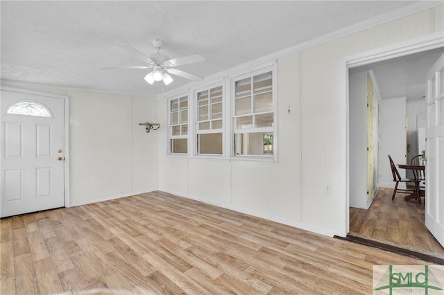 interior space featuring ceiling fan, light hardwood / wood-style flooring, and a textured ceiling