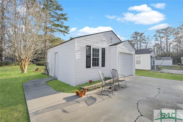 exterior space with a garage and a lawn