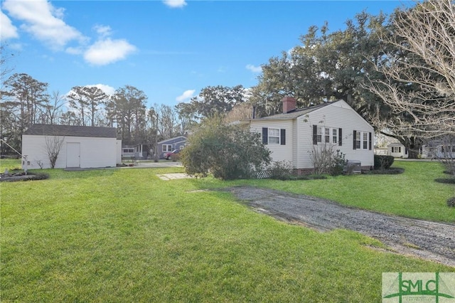 exterior space featuring an outbuilding and a lawn