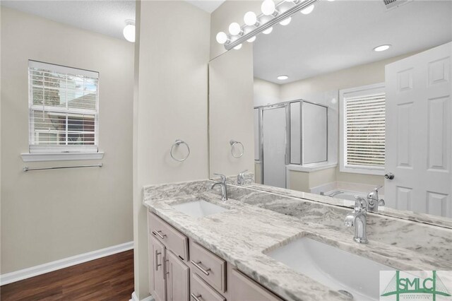 209 Mariners Way, Savannah, GA 31419 - bathroom featuring a stall shower, baseboards, wood finished floors, double vanity, and a bath
