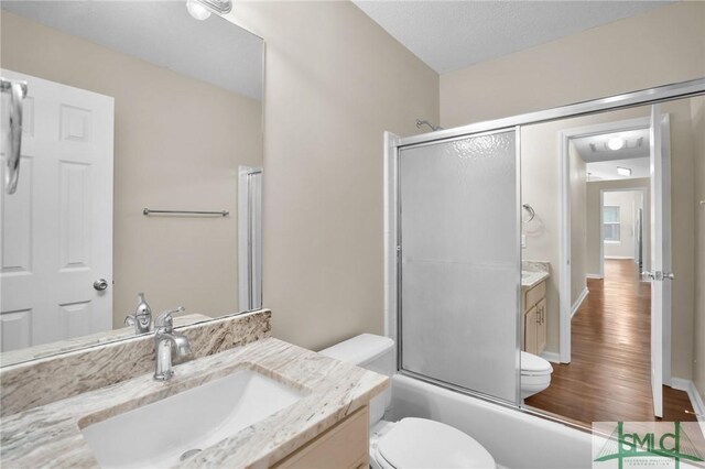 209 Mariners Way, Savannah, GA 31419 - bathroom featuring vanity, toilet, wood finished floors, and combined bath / shower with glass door
