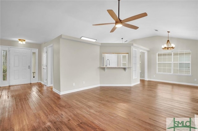 209 Mariners Way, Savannah, GA 31419 - unfurnished living room featuring ceiling fan, a chandelier, wood finished floors, lofted ceiling, and baseboards