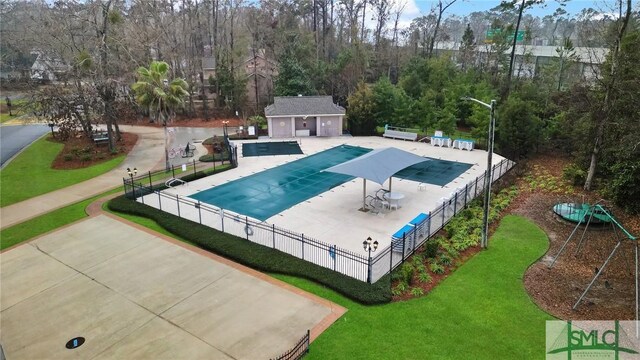 209 Mariners Way, Savannah, GA 31419 - community pool with a patio area, an outbuilding, and view of scattered trees