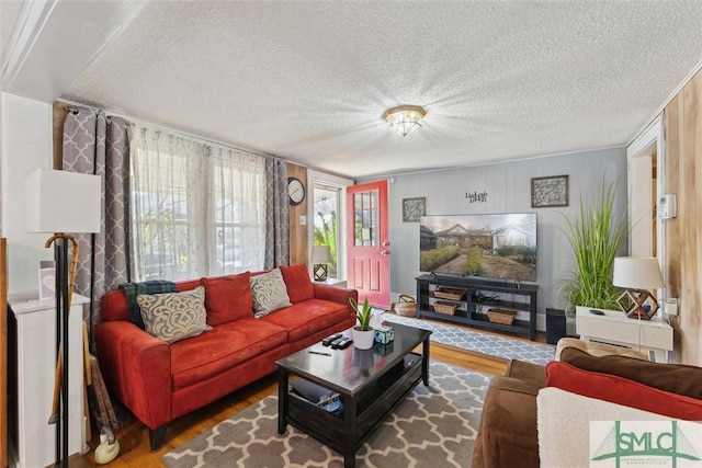 living room with hardwood / wood-style flooring and a textured ceiling