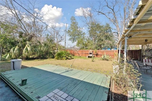 wooden terrace featuring a yard