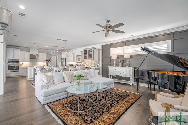 living room with ceiling fan, dark wood-type flooring, and crown molding