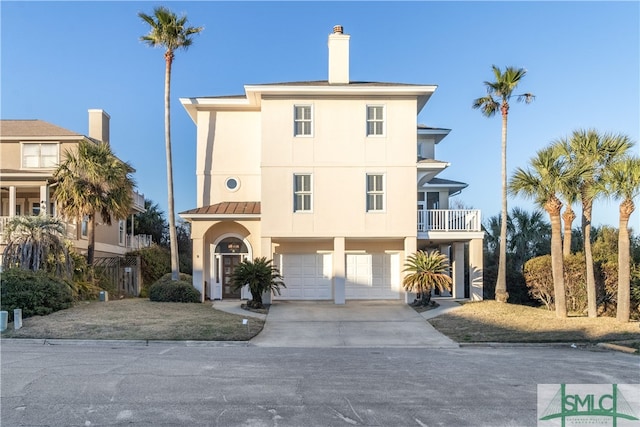 view of front of home with a garage and a balcony