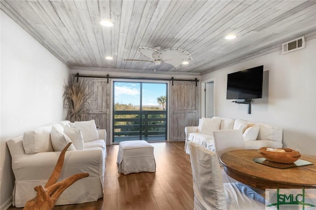 living room featuring hardwood / wood-style floors, wood ceiling, and a barn door